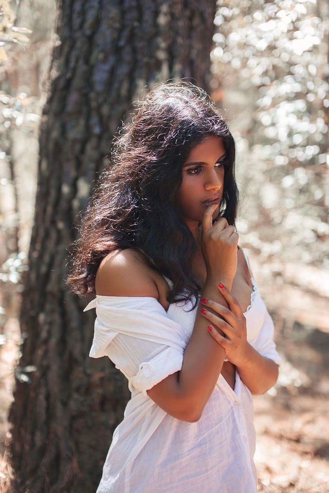Indian model Revathi Shan photographed in the forest wearing an elegant white dress