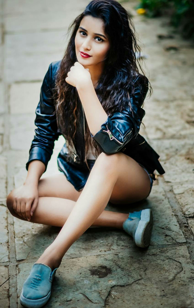 Mumbai based model Simran Gupta wearing a black leather jacket and blue shoes